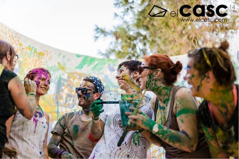 Smiling participants, faces and arms covered in paint