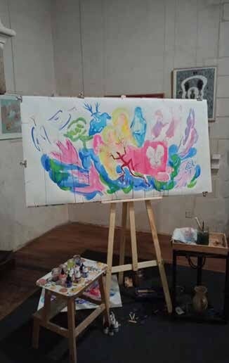 Brightly coloured drawing on an easel, in the room of The Snake Charmer