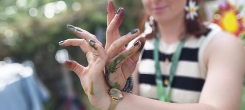 Close-up of hands stained with green paint